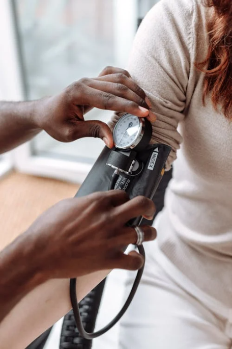 A family medicine doctor checking a patient's blood pressure during a wellness exam